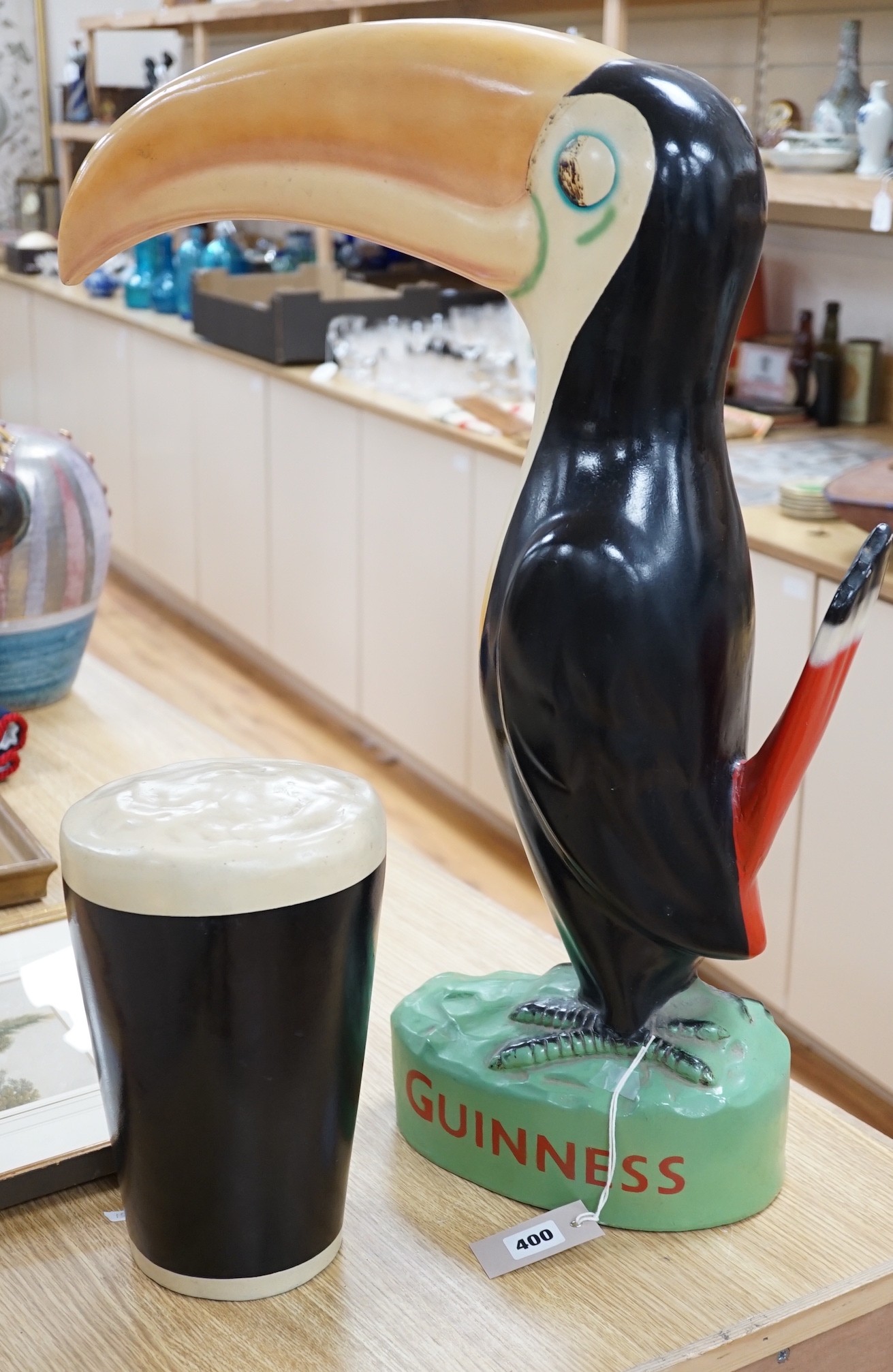 A large composition Guinness toucan, 66cm, and related pint ornament